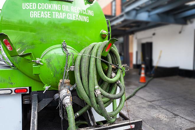 a grease trap pumping service in action at a commercial building in Cohutta